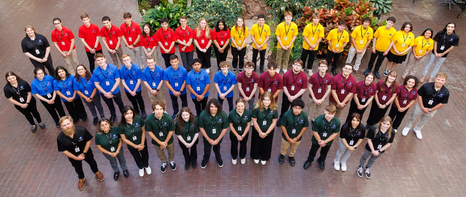 United Space School students from 2024 line up in their teams with their mentors and teachers.